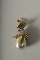 A RUSSIAN SILVER EGG AND HELMET PENDANT.