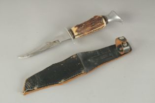 A SOLINGER GERMAN KNIFE with 4.5ins blade and bone handle, in a leather sheath.