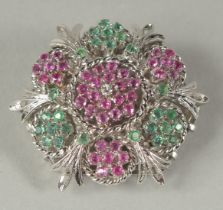 A GOOD 18CT WHITE GOLD DIAMOND RUBY AND EMERALD CIRCULAR BROOCH.
