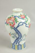 A CHINESE VASE PAINTED WITH FLOWERING TREES DESIGN. Six character mark. 8.5ins high.