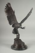 JULES MOIGNEZ (1815 - 1894). A SUPERB BRONZE OF AN EAGLE, WINGS OUTSTRETCHED with prey in it's claw.