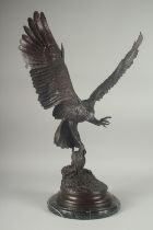 JULES MOIGNEZ (1815 - 1894). A SUPERB BRONZE OF AN EAGLE, WINGS OUTSTRETCHED with prey in it's claw.