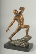 A SUPERB BRONZE ANATOMICAL MAN STANDING ON A ROCK, on a black marble base. 11ins high.