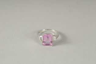A 10K WHITE GOLD PINK STONE AND DIAMOND RING.