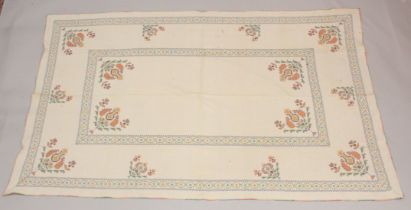 A NEEDLEWORK DECORATED BEDSPREAD with floral designs. 6ft 3ins x 4ft.