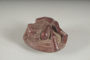 A JAPANESE CARVED WOOD MAN ON A CLAM, 1.75ins.