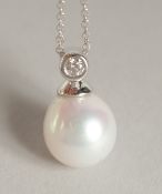 AN 18CT GOLD PEARL AND DIAMOND PENDANT on a chain in a box.