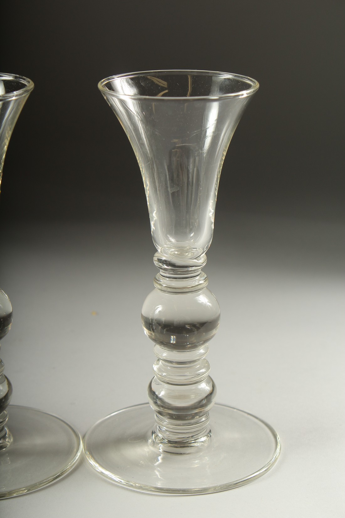 A SET OF FOUR PLAIN KNOP STEM WINE GLASSES. 7ins high. - Image 5 of 5
