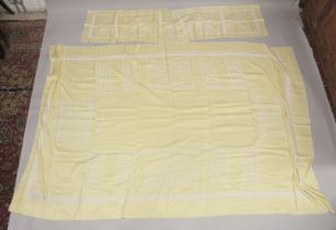 A YELLOW TABLECLOTH WITH MATCHING NAPKINS.