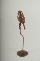 A JAPANESE BRONZE BIRD on a circular stand. 6ins high.