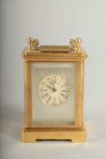 A MINIATURE CARRIAGE CLOCK with Sevres panel. 6cm high.