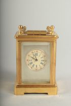 A MINIATURE CARRIAGE CLOCK with Sevres panel. 6cm high.