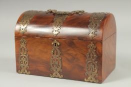 A VICTORIAN BRASS MOUNTED WALNUT DOMED CASKET with velvet interior. 9ins long.
