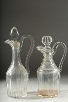 TWO HEAVY CUT GLASS CLARET JUGS AND STOPPERS.
