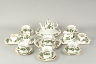 A QUEEN'S CHINA "YULETIDE" TEA SERVICE, comprising:seven various cups, saucers and plates, two