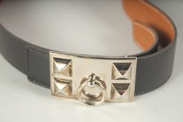 A HERMES BLACK LEATHER BAG with metal ring buckle.