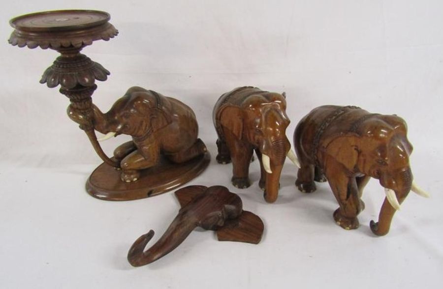 Wooden carved elephants includes a wall hanging head, a pair of elephants (one damaged to ear)