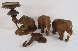 Wooden carved elephants includes a wall hanging head, a pair of elephants (one damaged to ear)