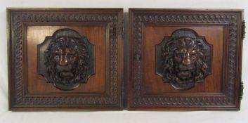 Pair of oak cupboard doors with lion head design sitting proud of the frame one with working lock