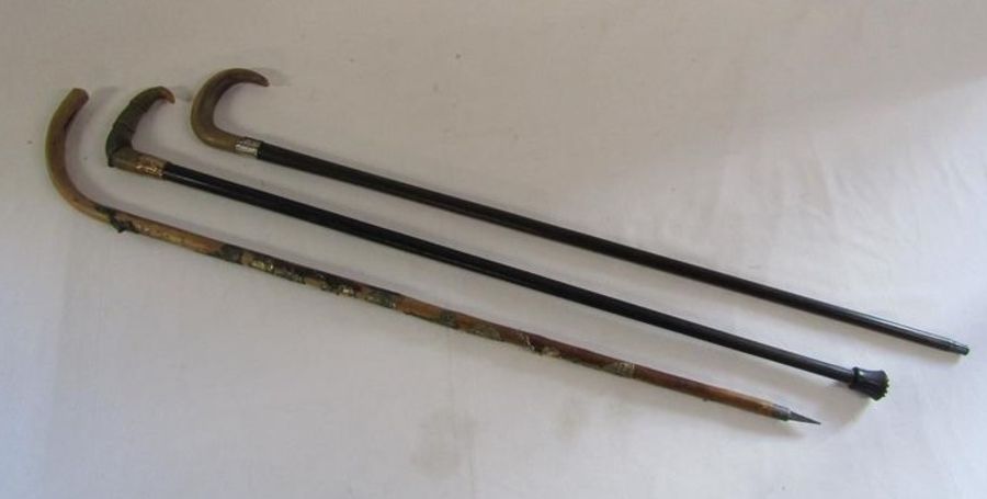 3 walking canes - wooden with stick badges, shaped horn handle and yellow metal collar and rounded