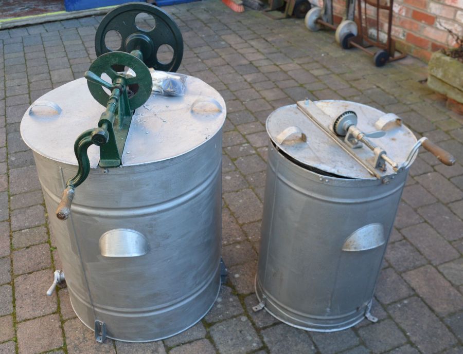 Two metal honey extractors