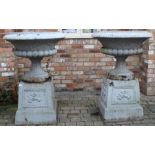 Pair of extremely large cast iron garden urns on pedestals with cherub design approx. 130cm H 92cm