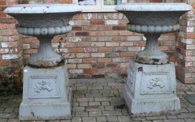 Pair of extremely large cast iron garden urns on pedestals with cherub design approx. 130cm H 92cm