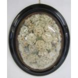 Ebonised oval frame with convex glass containing faux flower display - approx. 51cm x 43cm
