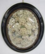 Ebonised oval frame with convex glass containing faux flower display - approx. 51cm x 43cm