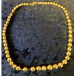 String of gold beads tested as 18ct. 29.7g length 40cm