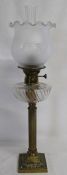 Victorian style brass oil lamp with reeded column, clear glass reservoir and etched glass shade