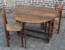 18th century style oak gate leg table (125cm by 107cm) with two rush seated chairs