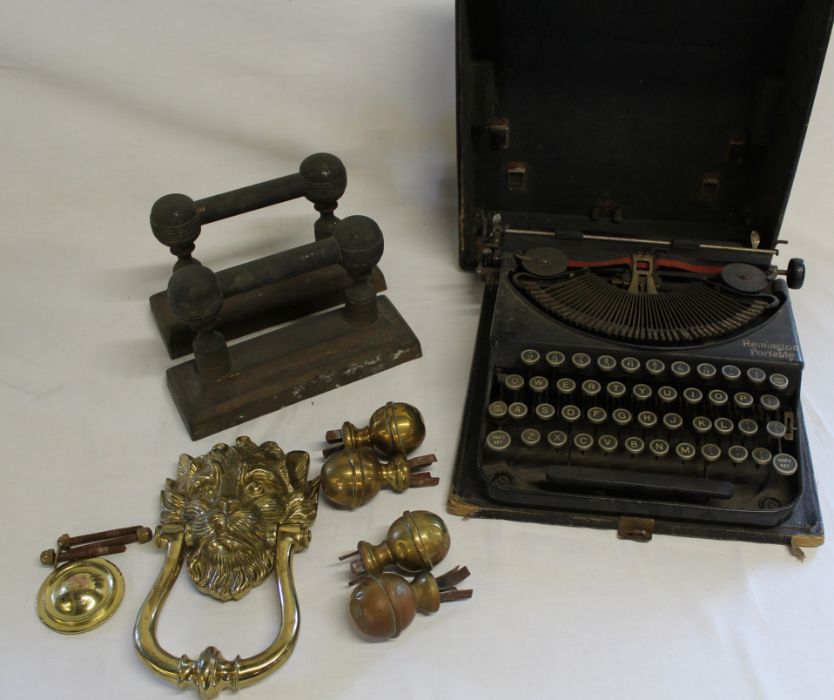 Pair of brass firedogs, brass lion door knocker, brass finials & Remington portable typewriter