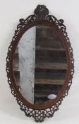 Oval mirror with inlaid fretwork frame approx. 64cm x 37cm