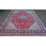 Rich red ground Persian Tabriz carpet with floral medallion & blue border 346cm by 259cm