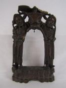 Oriental carved wooden altar depicting men carrying poppies and bird to the top with inlaid metal