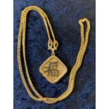 Gold Chinese pendant tested as 15ct on a gold chain tested as 18ct. Total weight 11.9g, chain length