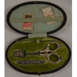 Leather sewing case containing silver handled scissors, needle case & thimble