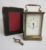 Cased brass carriage clock with key approx. 11cm tall to top of clock