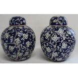 Pair of Chinese porcelain ginger jars with blossom decoration 26cm high (one cover a/f) with red