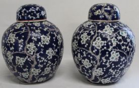 Pair of Chinese porcelain ginger jars with blossom decoration 26cm high (one cover a/f) with red