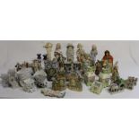 Selection of decorative bisque figurines, fairings, candlesticks etc.
