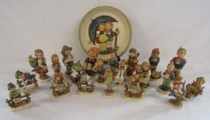 Collection of Goebel children figures also includes a plate signed Hummel (girl tying her shoe is