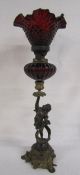 F.Schouval Paris bronze and brass cherub candlestick holding cranberry glass oil lamp reservoir