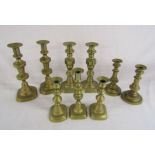 3 pairs of brass candlesticks and a triple set