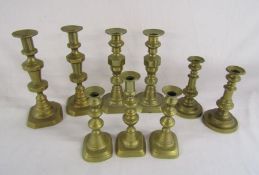 3 pairs of brass candlesticks and a triple set