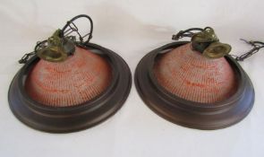 Pair of hanging ceiling lights, the glass bowls with copper effect rims