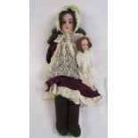 Mabel Germany bisque head doll with leather body showing damage to legs and a smaller bisque head