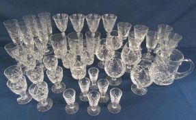 Collection of crystal glass ware includes brandy glasses, tumblers, flutes and a water jug
