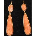 Pair of carved coral earrings set in tested as 9ct gold